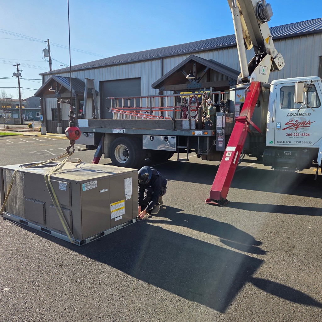Rigging HVAC equipment for a lift service pick with the Advanced Electric Signs crane truck