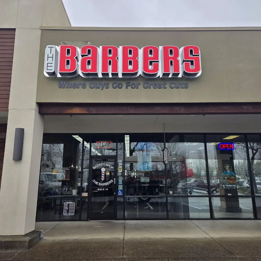 The Barbers storefront: pan channel letters, halo-lit, diamond plate backer